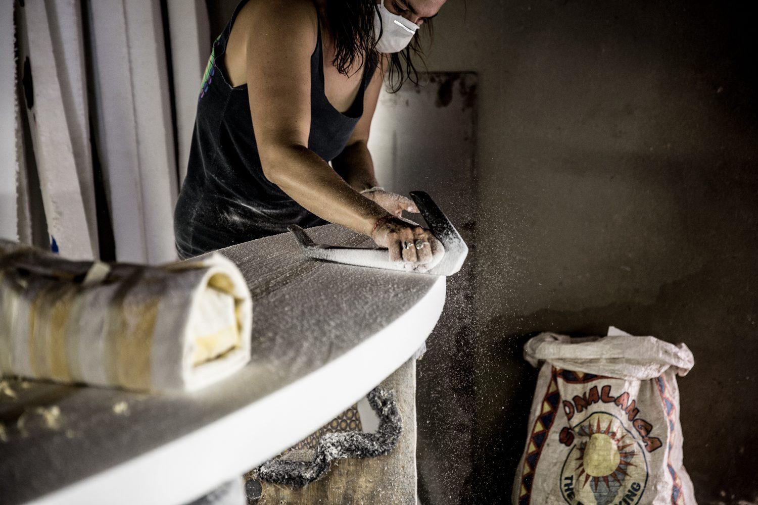 Jeniffer Bam shaping a surfboard