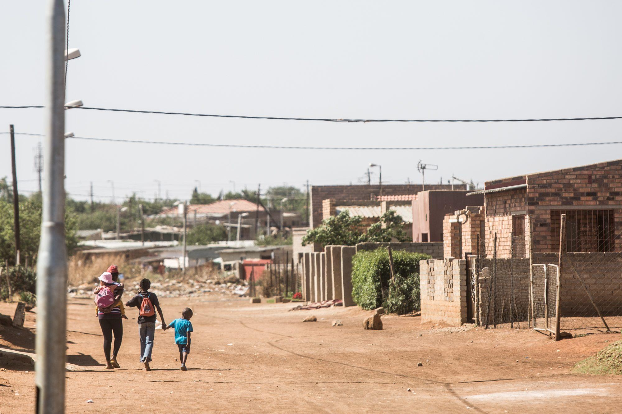 Children walking a township street — The Lunchbox Fund